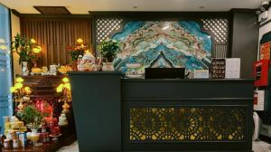 a fireplace in a store with a large painting on the wall at Min Boutique Hotel in Hà Ðông