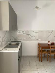 a kitchen with a sink and a table with a table at Agistri Island Dream in Skala +54 photos
