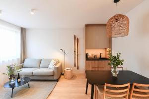 a living room with a table and a couch at Hotel Monínec - Depandance Apartmány in Moninec +26 photos
