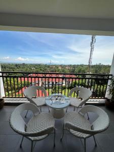 a table and chairs on a balcony with a view at Nyachaba Apartment in Kisumu