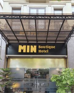 a min boutique hotel sign in front of a building at Min Boutique Hotel in Hà Ðông