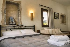 a bedroom with a large bed with towels on it at Castello in Porto Kagio