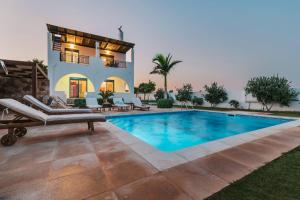 a villa with a swimming pool and a house at Deep Blue Villa in Lachania