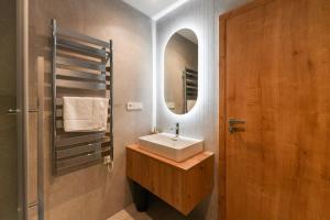 a bathroom with a sink and a mirror at Hotel Monínec - Depandance Apartmány in Moninec