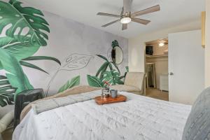 a bedroom with a bed with a plant mural at Quiet 2BR Kona Retreat Beach Gear BBQ Patio in Kailua-Kona