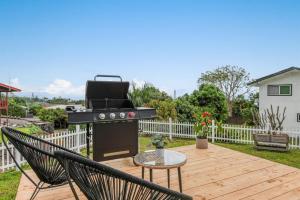 a barbecue on a deck with two chairs and a table at Quiet 2BR Kona Retreat Beach Gear BBQ Patio in Kailua-Kona