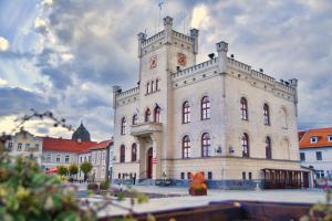 a large building with a clock tower on top of it at Cisza nad Kalwą in Pasym
