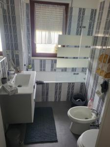 a bathroom with a sink and a toilet and a window at Civico 16 in Perugia +8 photos