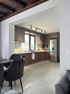 a kitchen with a table and a refrigerator at Guest House ELIYA in Devin