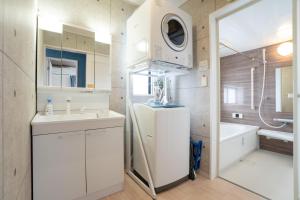 a bathroom with a sink and a washing machine at 古宇利島まで車で10分の星降るやんばるテラス海まで徒歩3分のは1棟貸 in Nago +71 photos