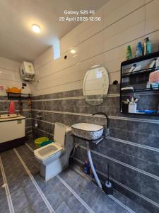 a bathroom with a toilet and a sink and a mirror at Happy Farmstead in Darjeeling