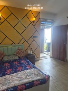 a bedroom with a bed and a wall at Happy Farmstead in Darjeeling