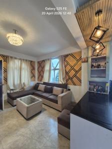a living room with a couch and a table at Happy Farmstead in Darjeeling