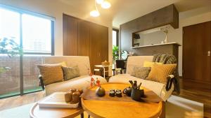 a living room with a couch and a table at EN Matsubara in Kagoshima