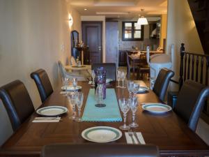 a dining room table with glasses and plates on it at George's Poet Maisonette in Rethymno