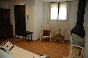 um quarto com uma cama e duas cadeiras e uma janela em Cal Marroso em Montsonis