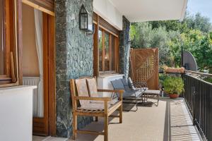 a row of chairs sitting on a porch at Casa Braun in Bonassola