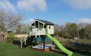 a play house with a slide in a yard at Die kleine Feine in Olmscheid