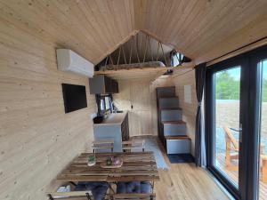 a interior of a tiny house with a desk and a sink at Lahod Tiny House by Tiny Away in Žalec