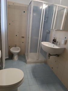 a bathroom with a shower and a toilet and a sink at Casa Tamerici in Marcelli