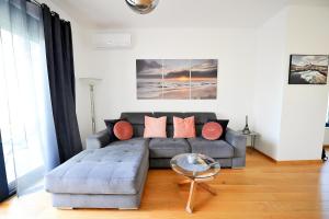 a living room with a couch and a table at SeaWolf Apartment in Bečići +41 photos