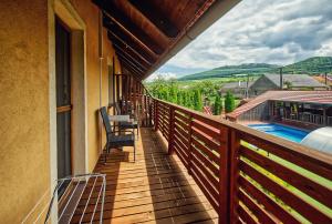 a balcony with chairs and a swimming pool at U Jeřába - komplex A in Horní Věstonice