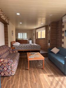a living room with a couch and a table at Batroun Souq, Perfect location, 1 Bedroom in Batroûn