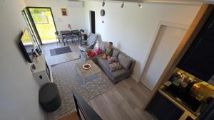 two children sitting on a couch in a living room at Vila Duplex in Lipovica