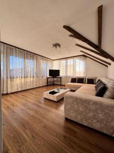 a living room with a couch and a tv at Voila House in Voila