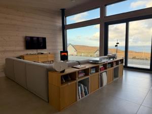 a living room with a couch and a large window at Luxury Nordic Lodge with private Sauna in Glendale