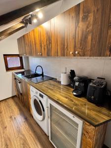 a kitchen with a sink and a washing machine at Voila House in Voila +6 photos