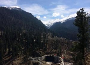 a view of a valley with snow capped mountains at Asaka Lodge in Kasol