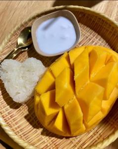 a plate of food with a mango and a spoon at Asaka Lodge in Kasol