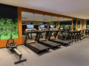 a gym with rows of cardio bikes and tread machines at ثريو thrio للشقق المخدومة in Riyadh