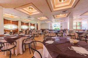 a banquet hall with tables and chairs in a room at VOI Florio Resort in Cinisi