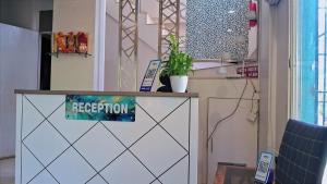 a reception desk with a potted plant on top of it at Tejas Grand villa baner in Pune