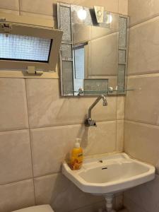 a bathroom with a sink and a mirror and a toilet at Batroun Souq, Perfect location, 1 Bedroom in Batroûn