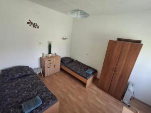 a bedroom with a bed and a wooden cabinet at Benkovac sobe in Benkovac