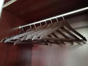 a bunch of utensils are hanging on a rack at Selah Hotel Dipolog in Dipolog