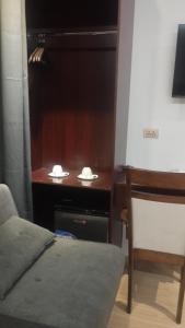 a room with a desk with a bed and a chair at Selah Hotel Dipolog in Dipolog +6 photos