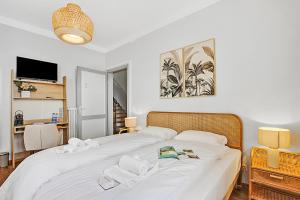 a bedroom with a large white bed with towels on it at Rooms in Villa Agra in Agra