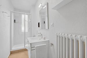 a white bathroom with a sink and a shower at Rooms in Villa Agra in Agra +69 photos