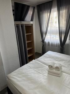 a bedroom with a bed with two towels on it at Hotel Rhein INN in Remagen