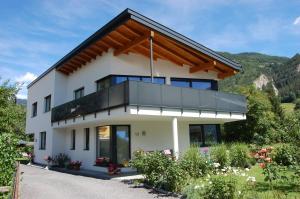 a house in the mountains with a balcony at Apart Patscheider in Ried im Oberinntal