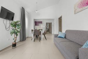 a living room with a couch and a table at LotusPoolApart in Premantura