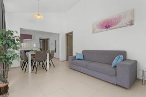 a living room with a couch and a table at LotusPoolApart in Premantura