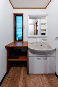 a bathroom with a sink and a mirror at BASE CAMP Kitakaruizawa in Naganohara +36 photos