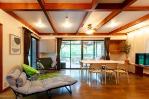 a living room with a table and chairs at BASE CAMP Kitakaruizawa in Naganohara