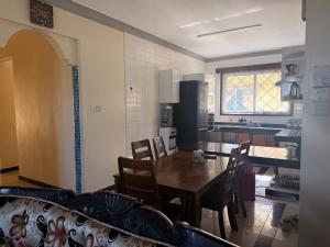 a kitchen and dining room with a table and chairs at Ahfash Homes in Mombasa +20 photos