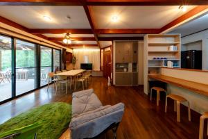 a kitchen and living room with a table and chairs at BASE CAMP Kitakaruizawa in Naganohara